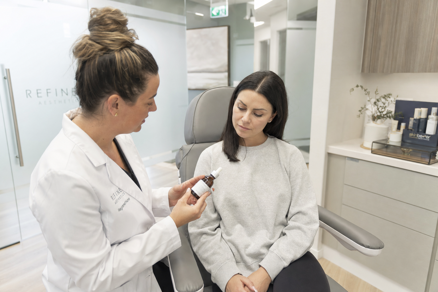 Nurse reviewing medical-grade skincare products with a relaxed client in a modern Toronto clinic